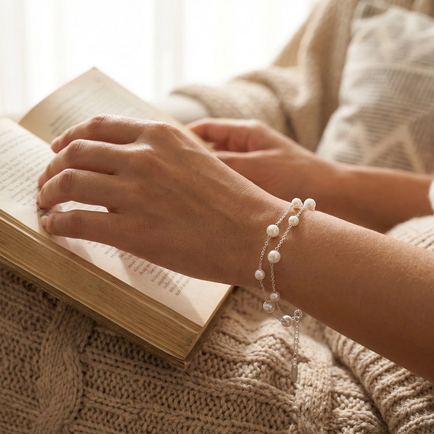 Double layer pearl bracelet with adjustable clasp on soft background