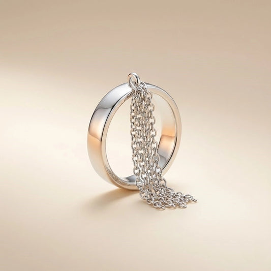 Silver ring with chain on a beige background