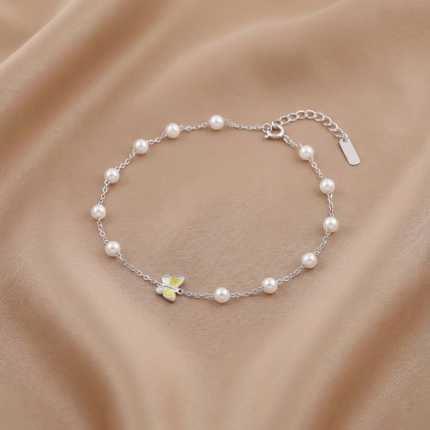 Silver chain bracelet with white pearls and butterfly charm