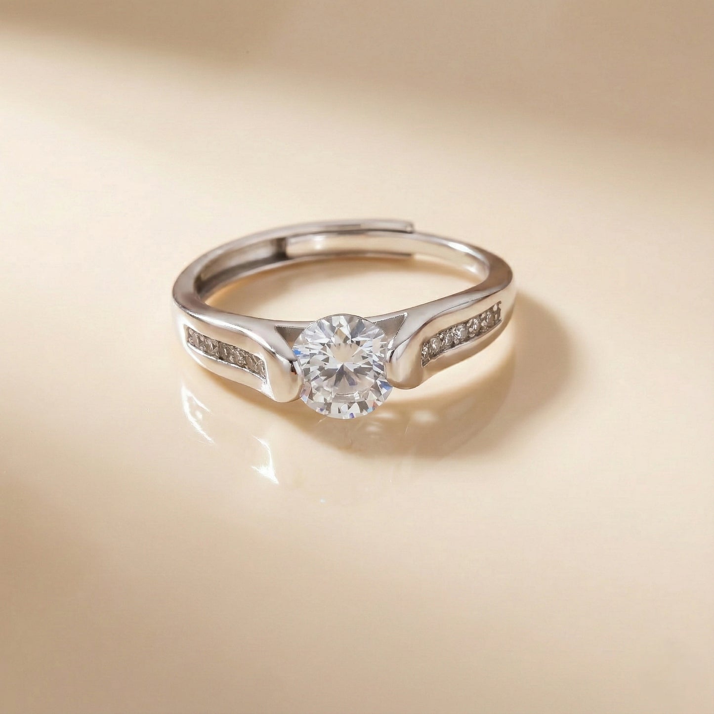 Silver ring with a diamond on a beige background