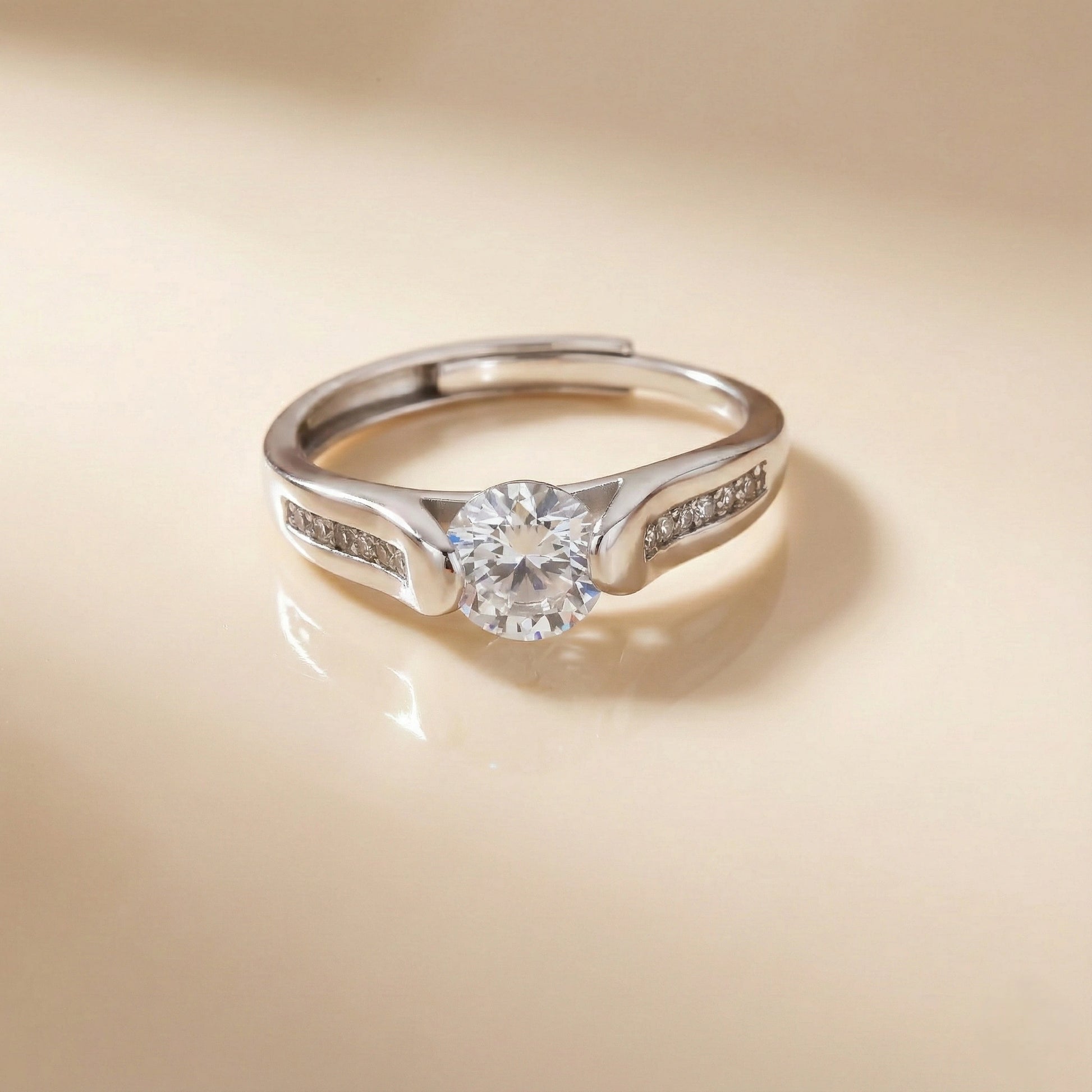 Silver ring with a diamond on a beige background