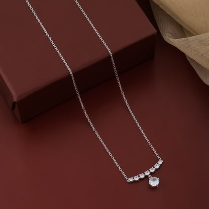 Silver necklace with a pendant on a brown surface
