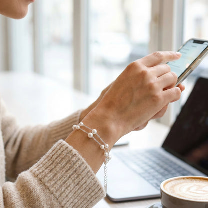Minimalist pearl bracelet jewellery flat lay close up