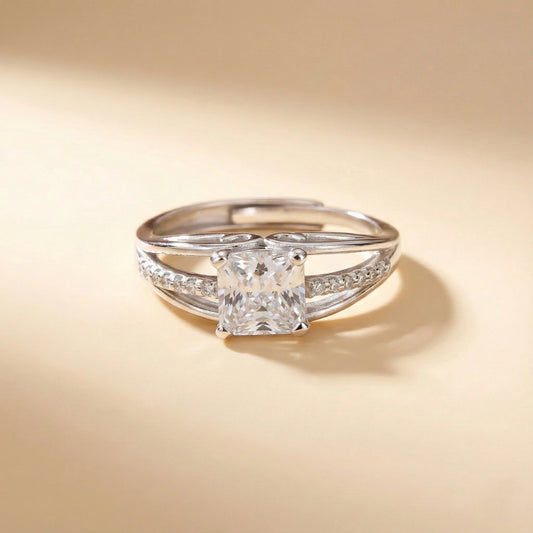 Silver ring with a large diamond on a beige background