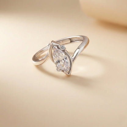 Silver ring with a large diamond on a beige background