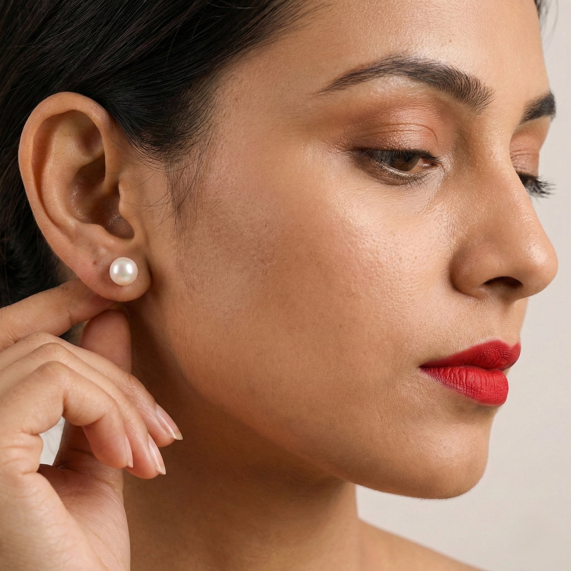 Pearl earrings on a light gray background