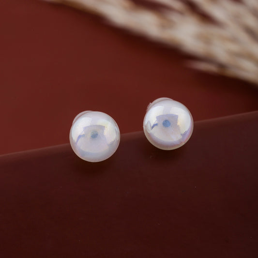 Pair of round pearl stud earrings showing smooth reflective surface