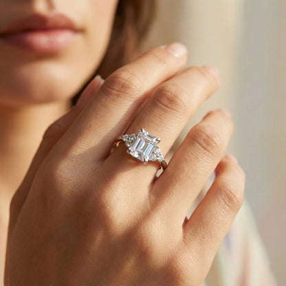 Close-up of a hand wearing a diamond ring with a blurred background