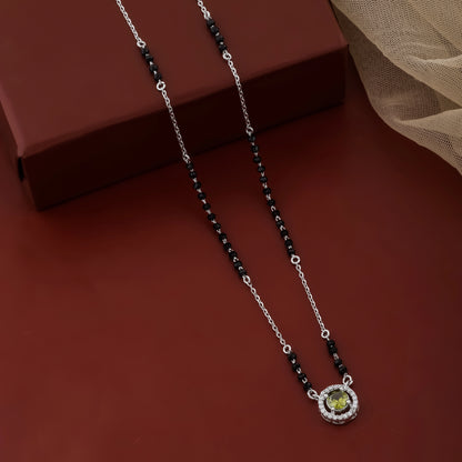 Indian mangalsutra crafted in sterling silver with black beads and green gemstone