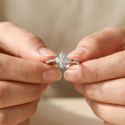 Close-up of hands holding a diamond ring against a blurred background