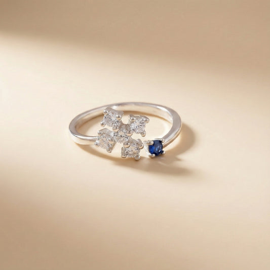 Silver ring with diamond and sapphire on a beige background