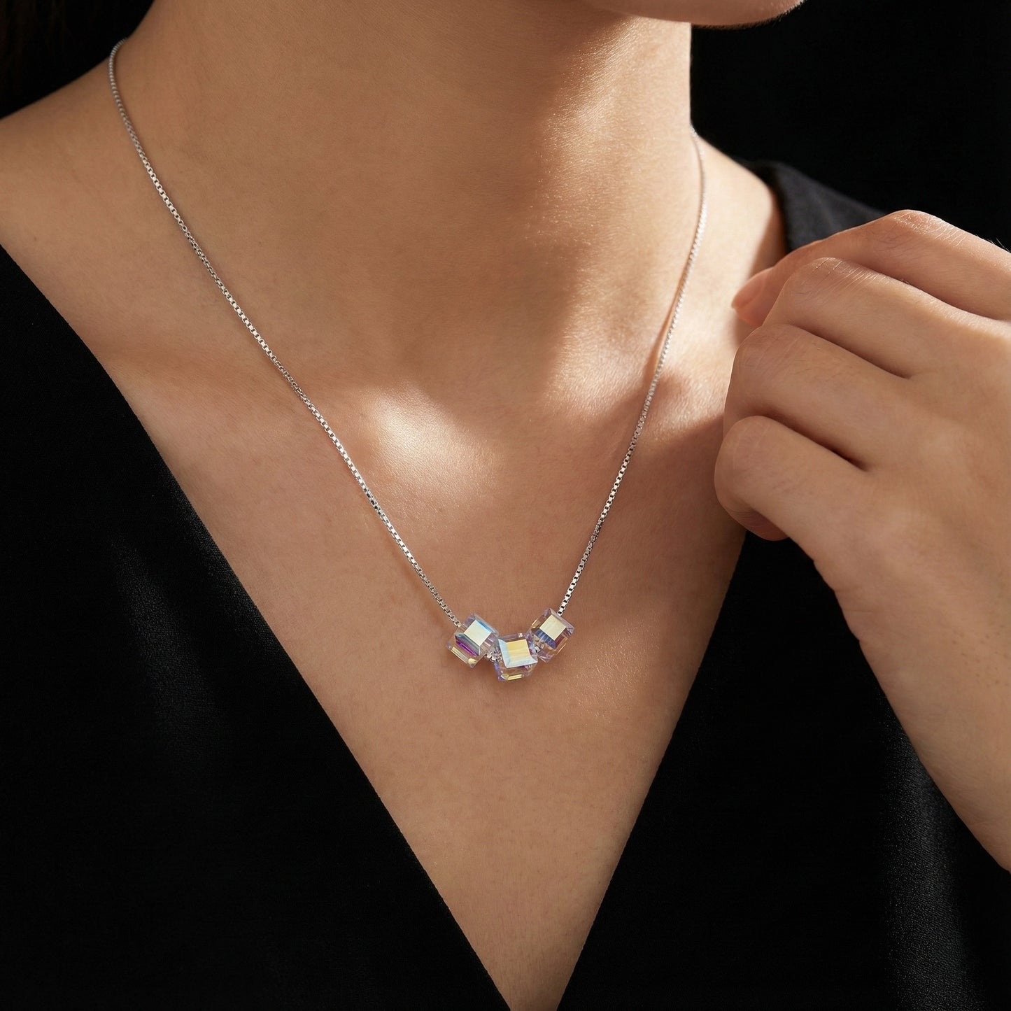 Necklace with a pendant on a person wearing a black top