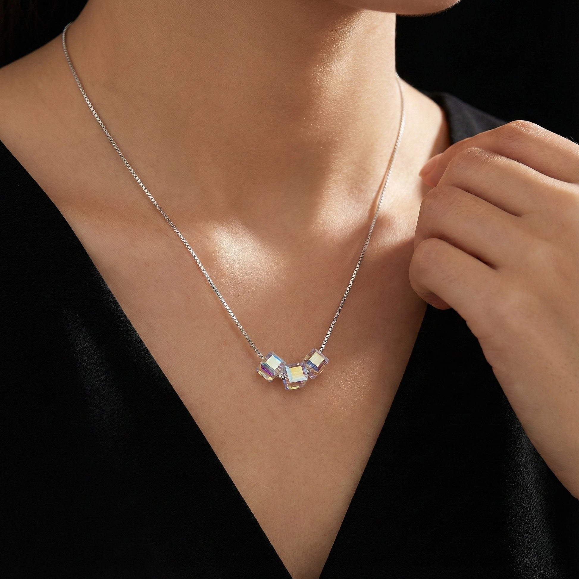Necklace with a pendant on a person wearing a black top