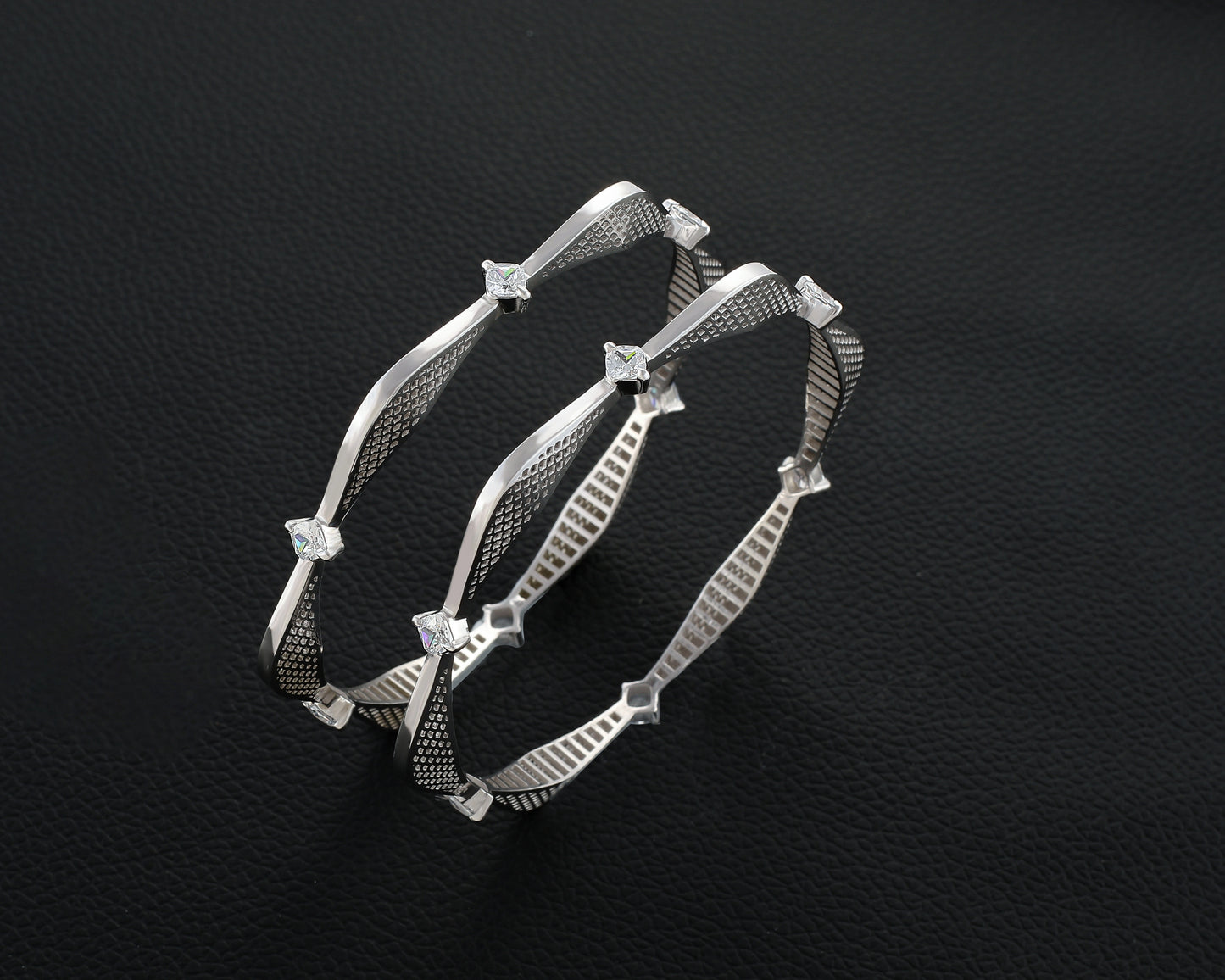 Silver bracelet with star-like embellishments on a dark textured background