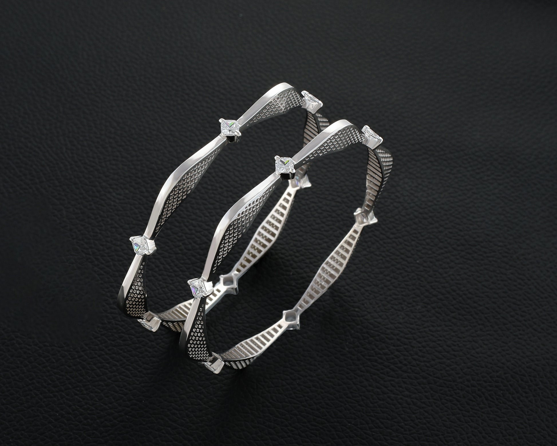 Silver bracelet with star-like embellishments on a dark textured background