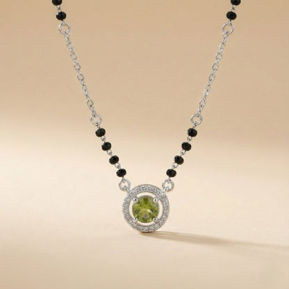 Modern mangalsutra necklace with black beads and green center stone halo design