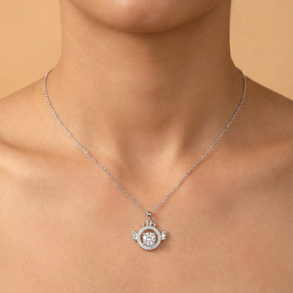 Silver necklace with a pendant on a person against a beige background