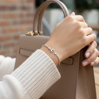 Hand holding a beige handbag with a blurred background