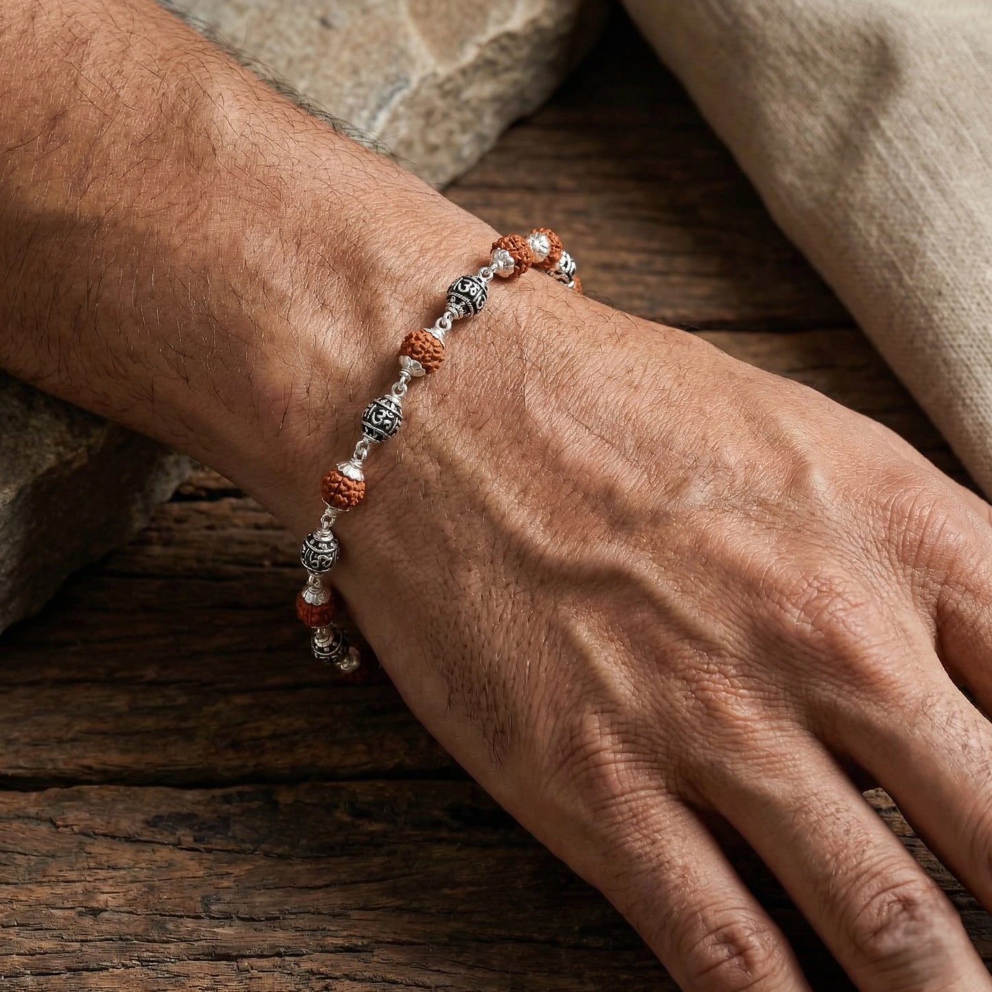 Silver bracelet with natural rudraksha beads in flat lay style