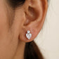 Heart-shaped diamond earring worn by a person