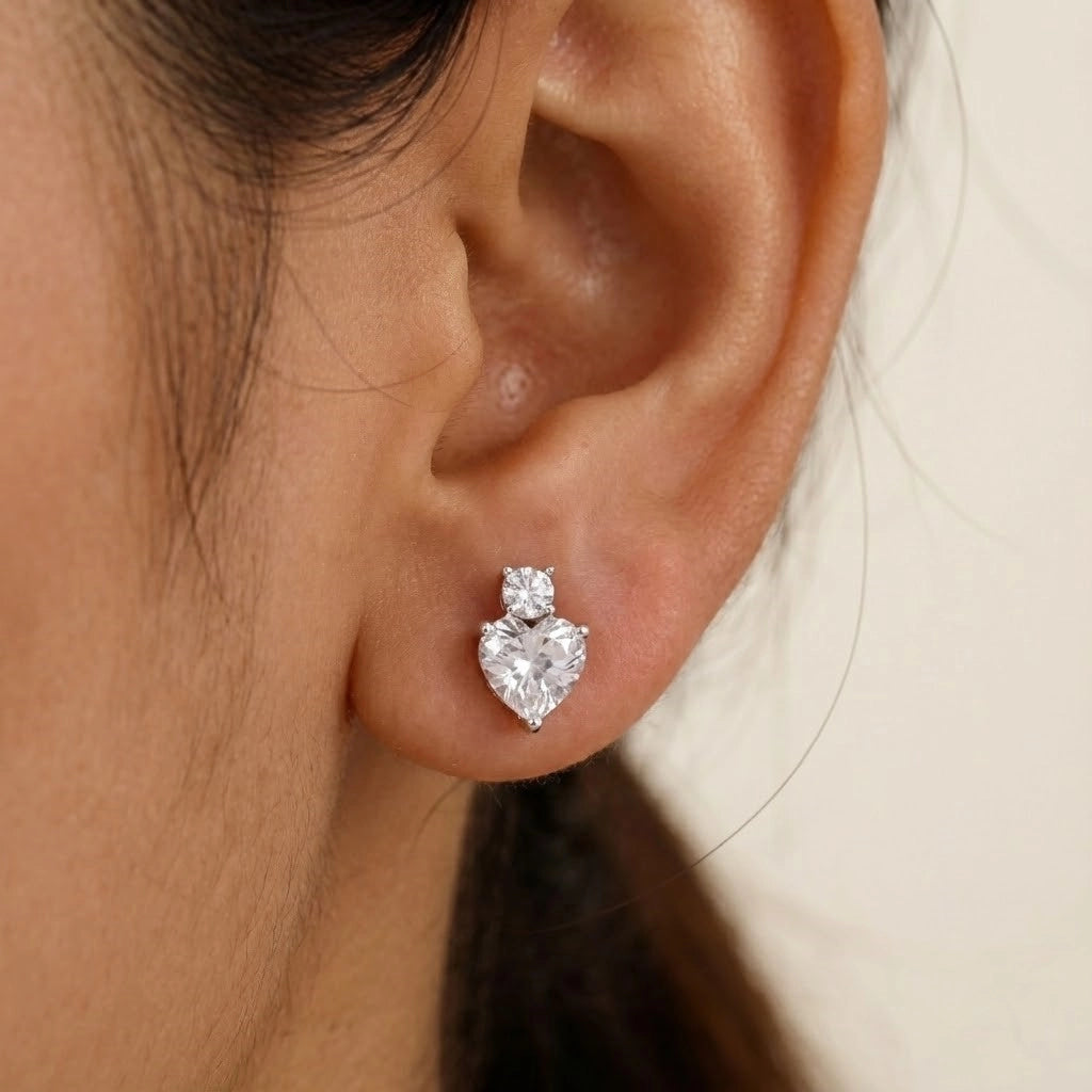 Heart-shaped diamond earring worn by a person