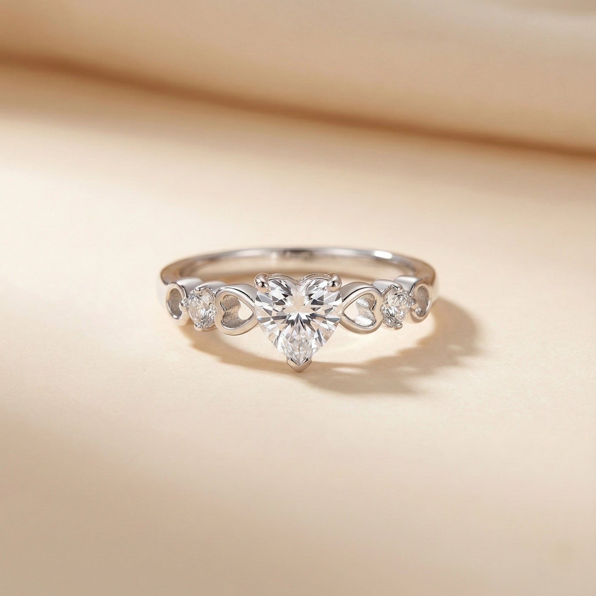 Silver ring with floral design and clear gemstones on a beige background