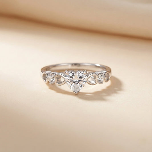 Silver ring with floral design and clear gemstones on a beige background