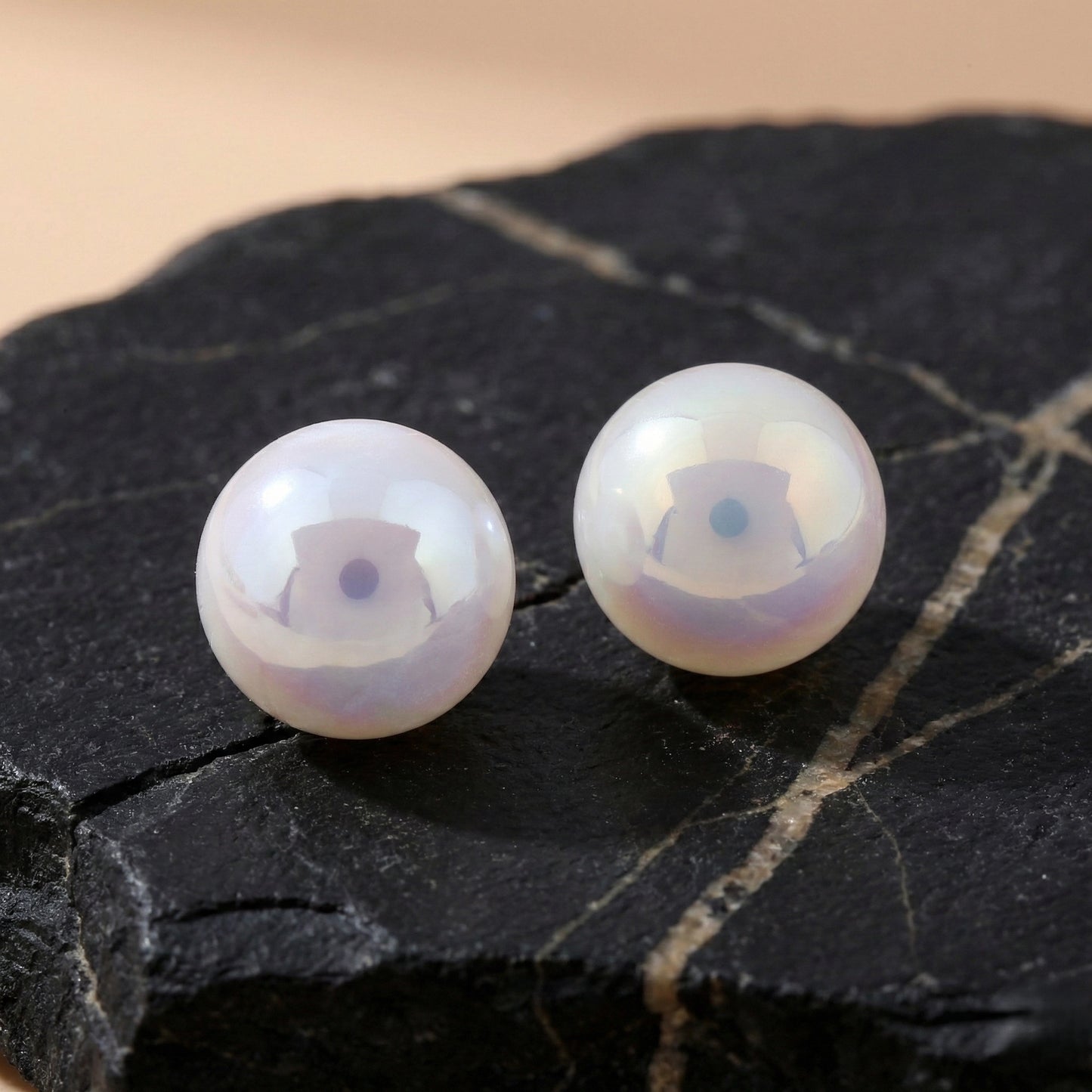 Elegant pearl stud earrings highlighting their lustrous coating and smooth texture