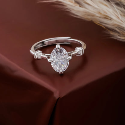 Silver ring with a large diamond on a brown fabric background