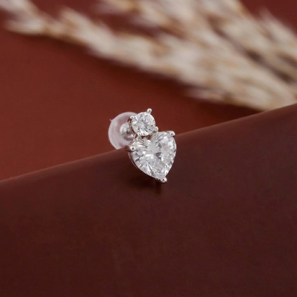 Diamond earring on a brown surface with blurred background