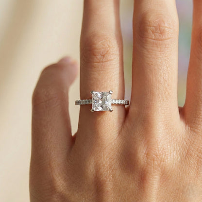 Diamond ring on a finger with a blurred background