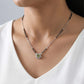 Minimal silver mangalsutra with traditional black beads and circular green stone pendant