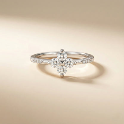 Silver ring with diamond flowers on a beige background