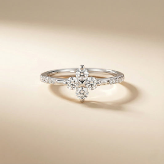 Silver ring with diamond flowers on a beige background