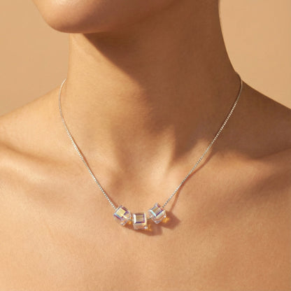 Necklace with colorful beads worn by a person on a beige background