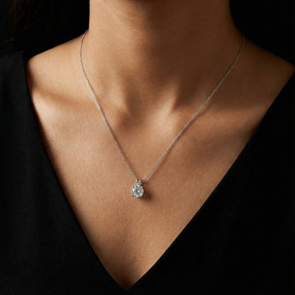 Necklace with a pendant worn by a person against a dark background