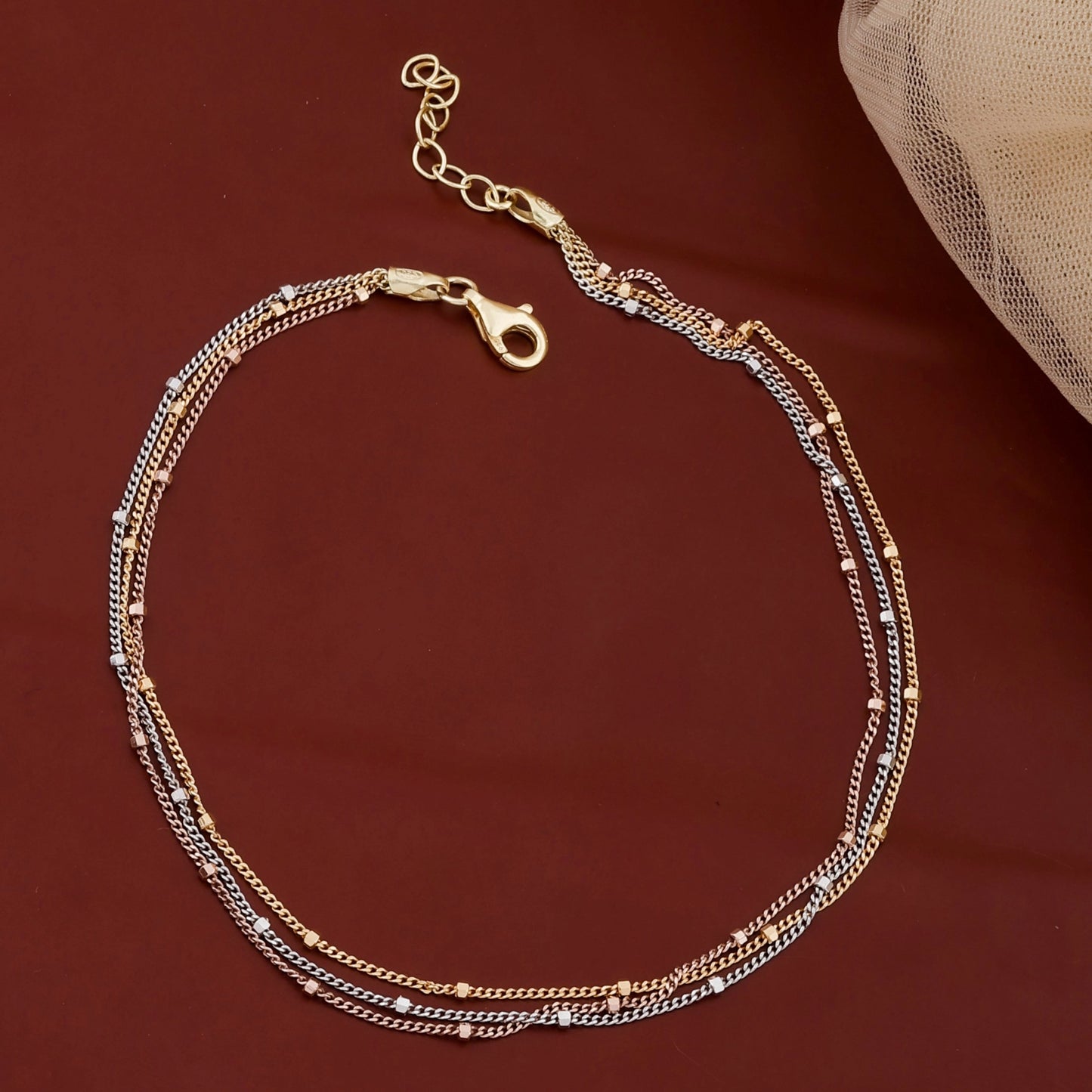 Gold chain bracelet on a brown background