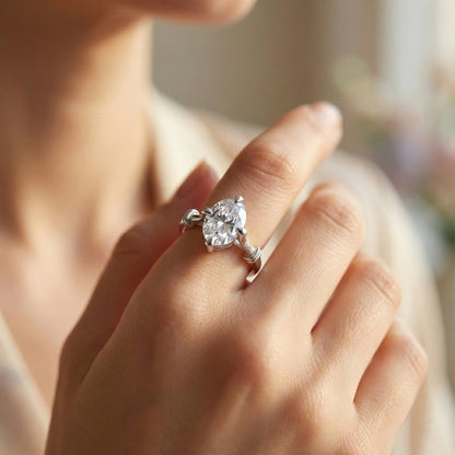 Close-up of a hand wearing a diamond ring with a blurred background