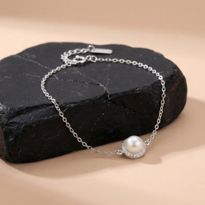 Sterling silver bracelet featuring round pearl centerpiece