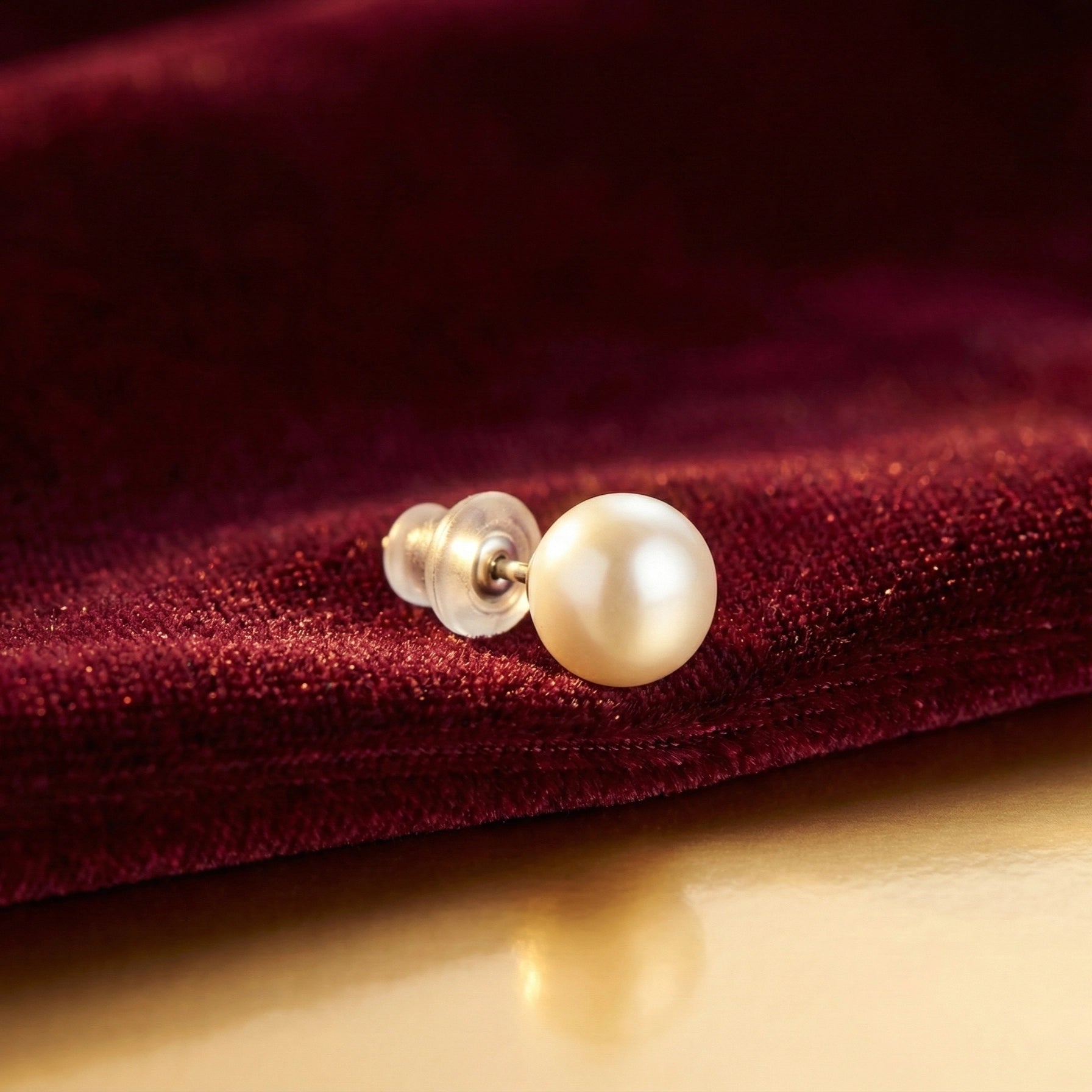 Close-up of classic white pearl stud earrings arranged side by side