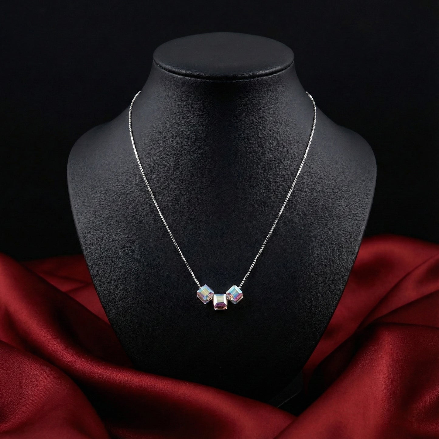 Necklace with a pendant on a black mannequin bust against a dark background