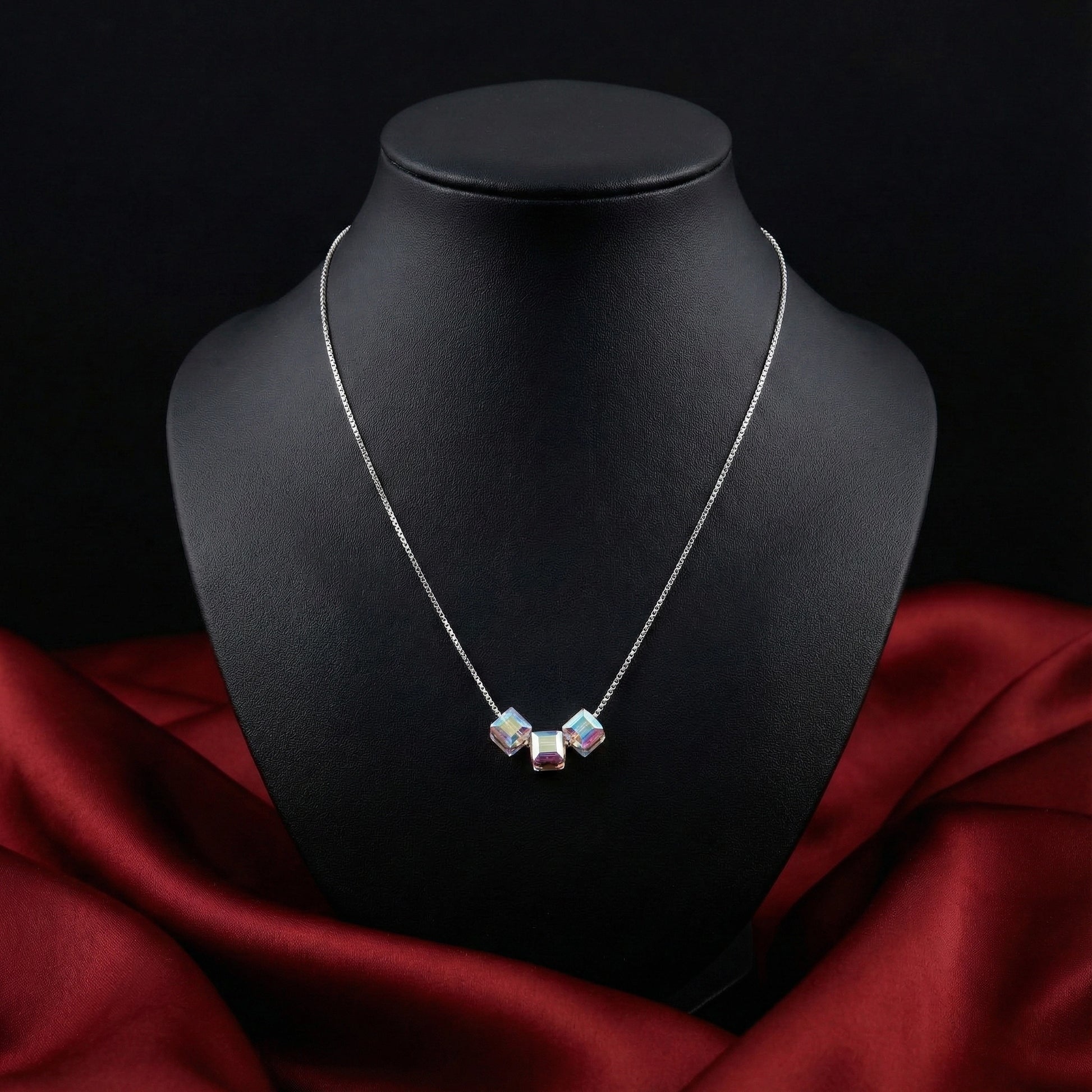 Necklace with a pendant on a black mannequin bust against a dark background