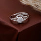 Silver ring with a diamond on a brown fabric background