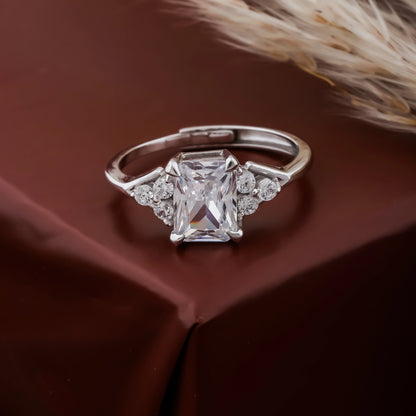 Silver ring with a large diamond on a brown fabric background