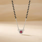 Necklace with a red gemstone pendant on a beige background