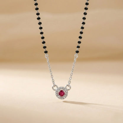 Necklace with a red gemstone pendant on a beige background