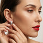 Close-up of a woman wearing a silver earring with red lipstick.