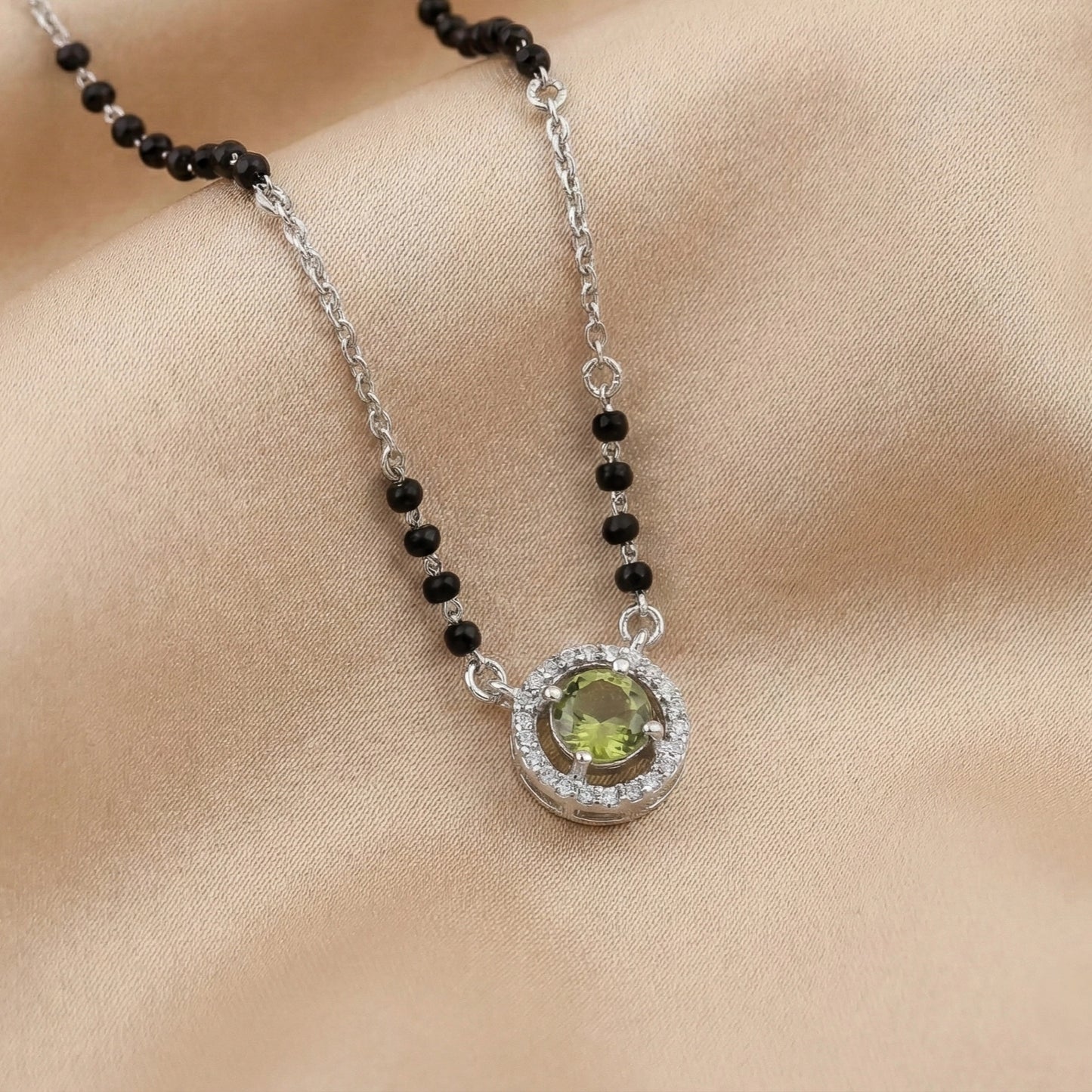 925 sterling silver mangalsutra with black beads and a green stone halo pendant