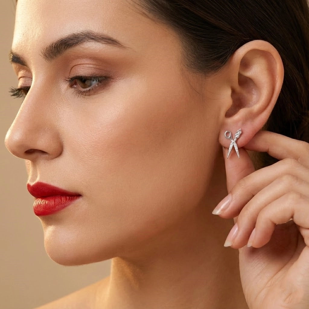 Close-up of a woman wearing a silver earring with a beige background