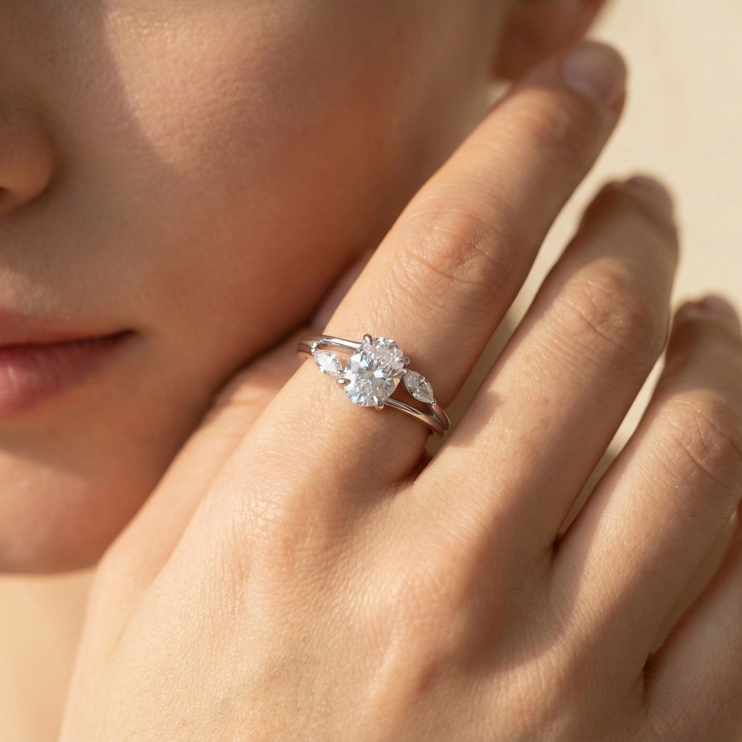 Close-up of a hand wearing a diamond ring with a soft focus background